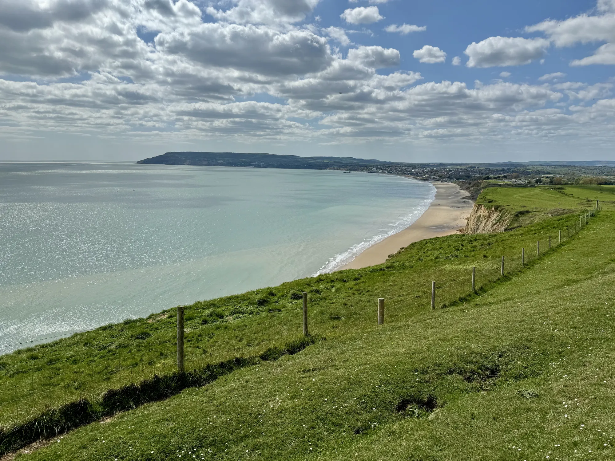 Green clifftop above Yaverland and Sandown Bay with Culver Down in view