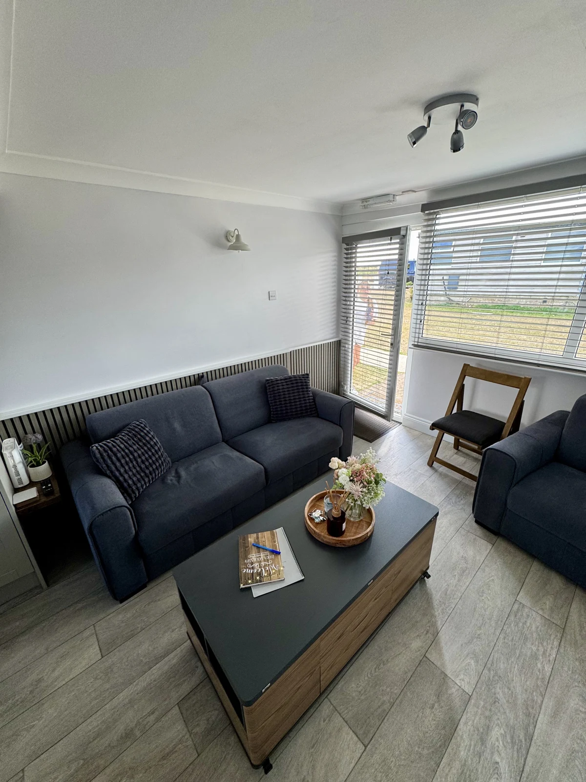 Yaverland Breeze living room showing the sofa, armchair, coffee table and front window