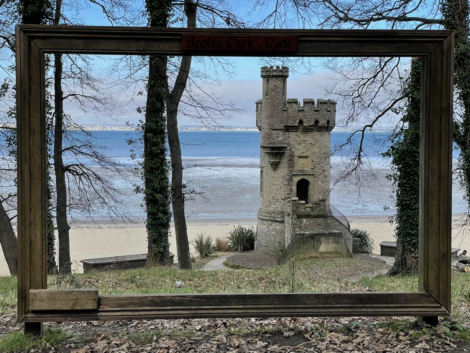 Seafront folly tower framed by a giant picture frame on an Isle of Wight beach