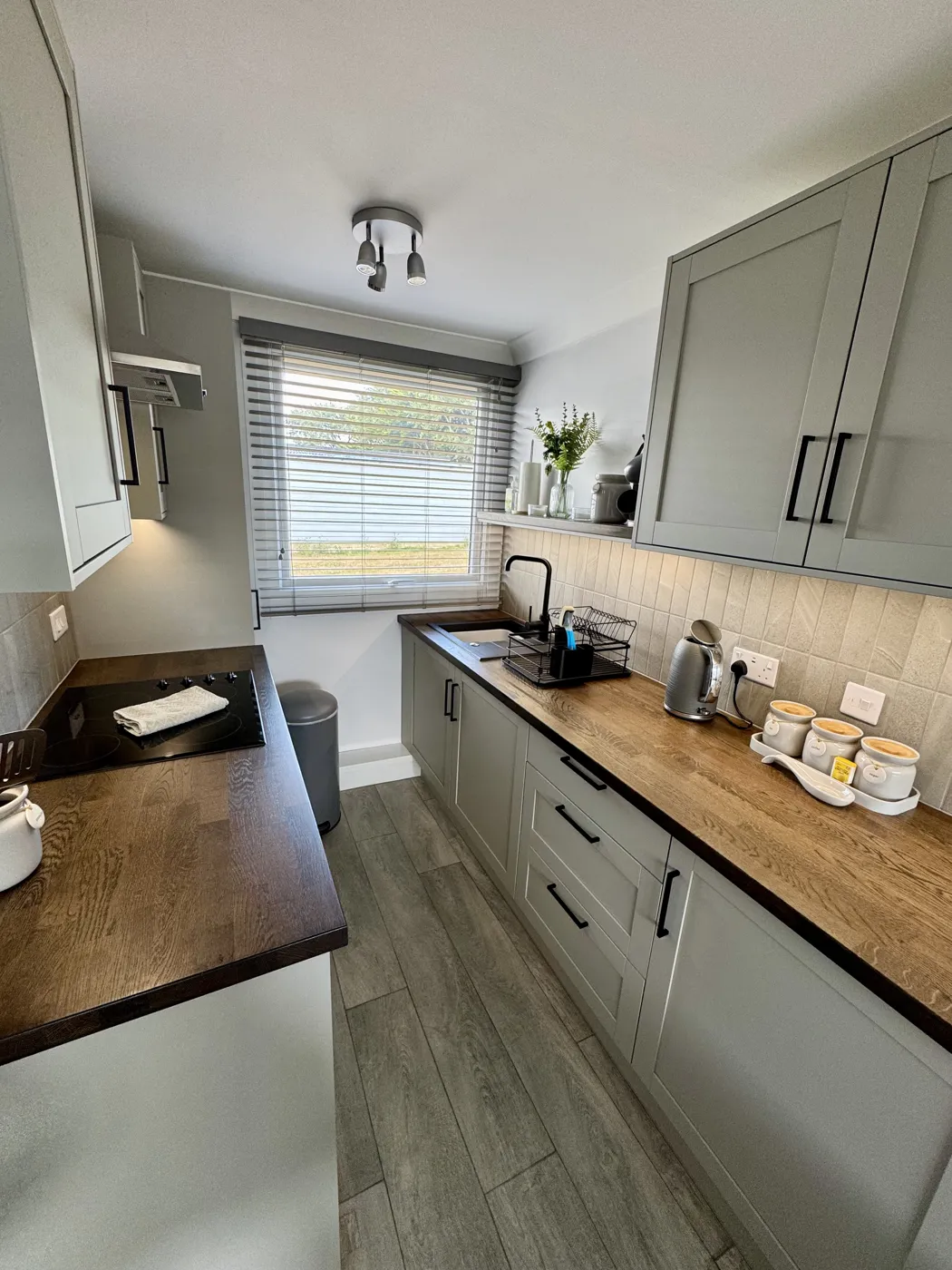 Yaverland Breeze kitchen with sage cabinets and wooden worktops