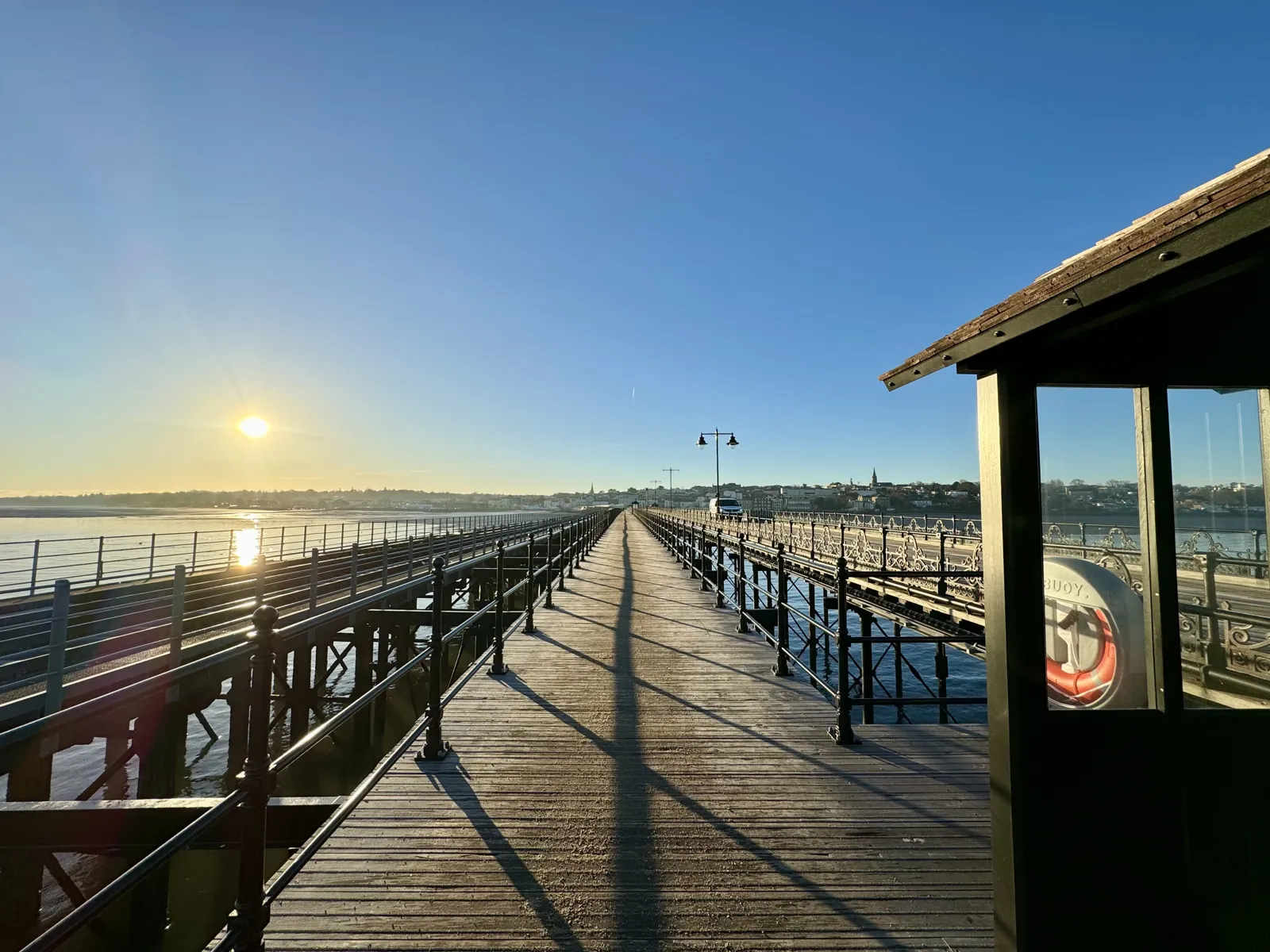 Long wooden pier stretching out to sea at sunrise on the Isle of Wight