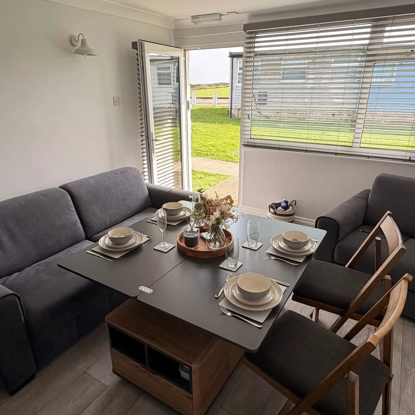 Dining table laid for four beside the patio doors at Yaverland Breeze
